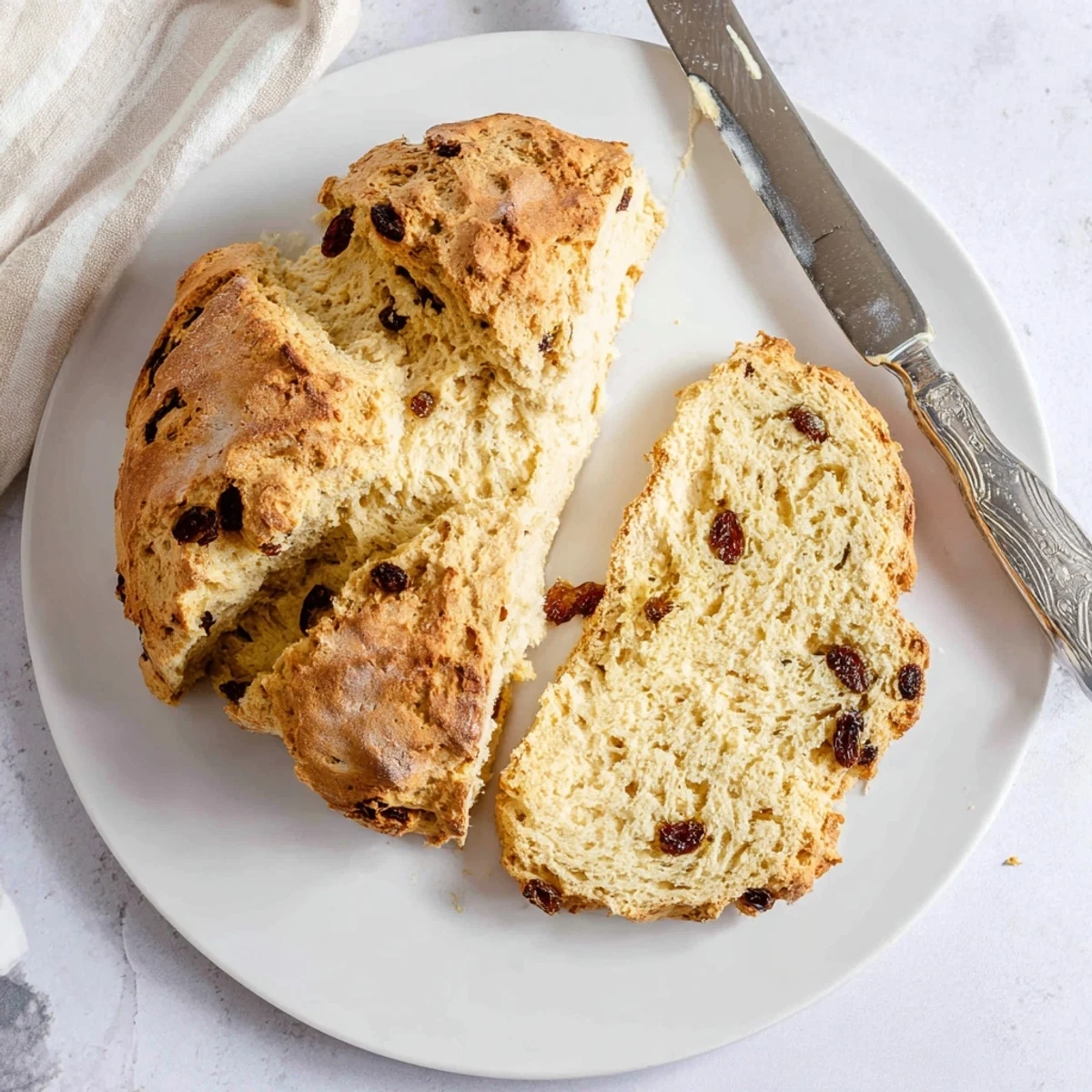 A freshly baked Classic Irish Soda Bread loaf, golden brown with a crispy crust.  
