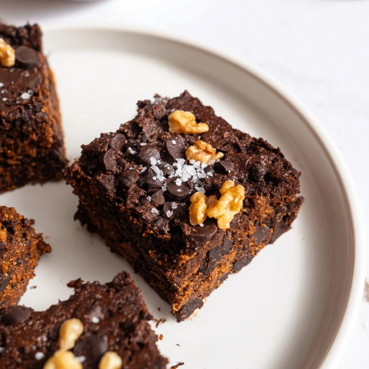 A plate of delicious sweet potato brownies, a gluten-free dessert packed with chocolatey goodness.