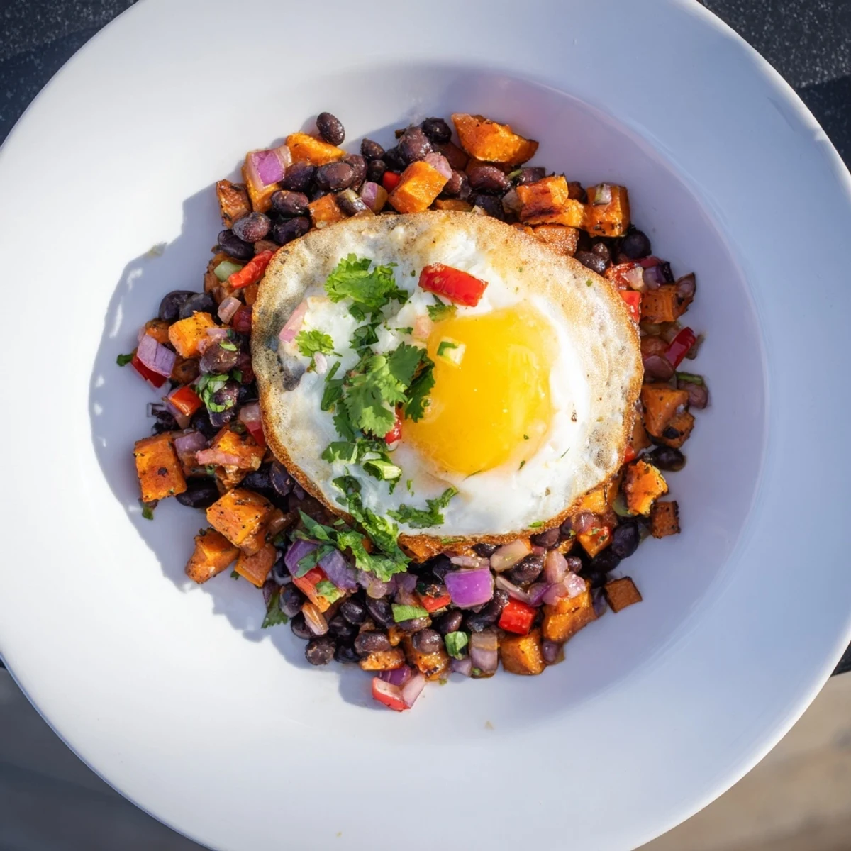 Sizzling skillet displaying a hearty, flavorful sweet potato and black bean breakfast hash ready to serve.
