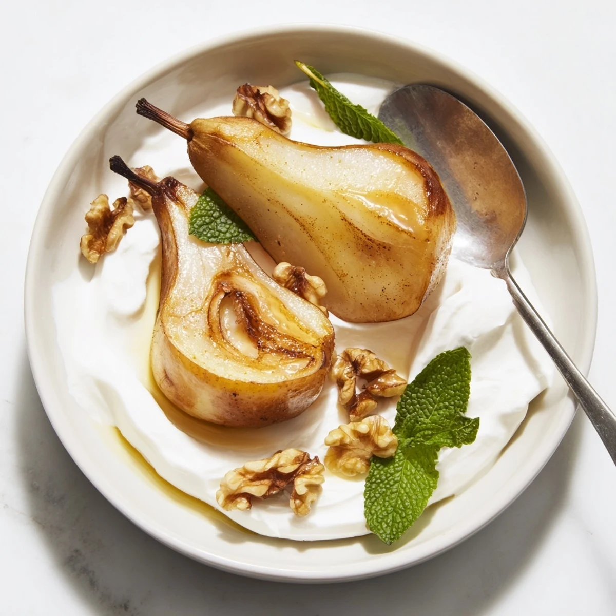 Perfectly cooked Roasted Pears, served with crunchy walnuts and a dollop of cool Greek yogurt.