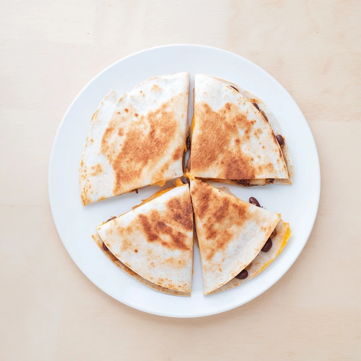 Golden, crispy Bean & Cheese Quesadillas are filled with melted cheese, ready for dipping into salsa.