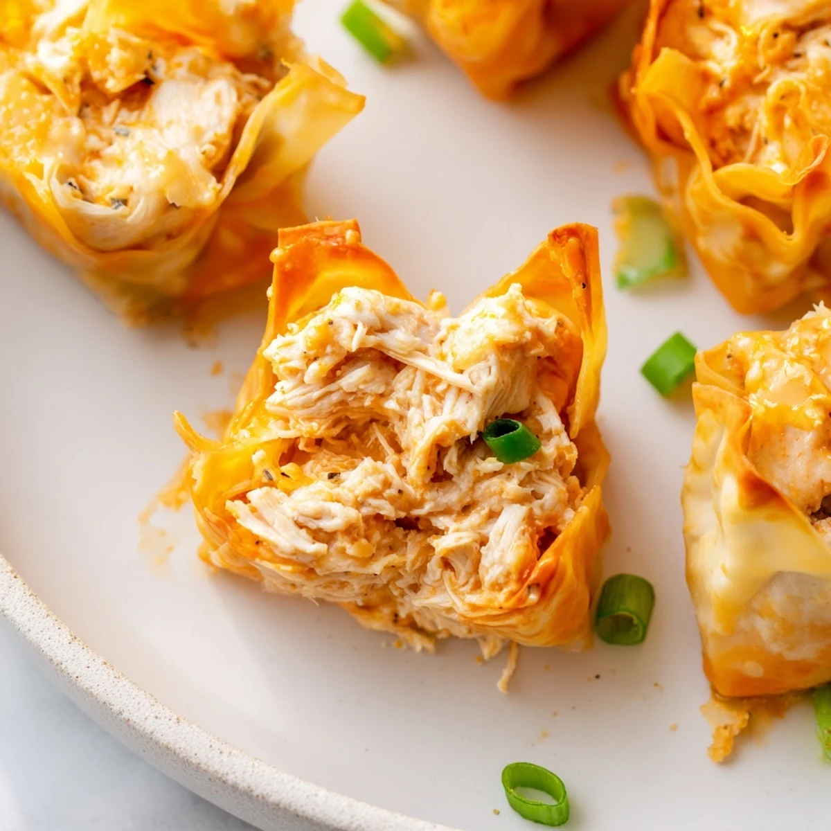 Golden, crispy Buffalo Chicken Dip Pinwheel Wonton appetizers, perfect for game day snacking and parties.
