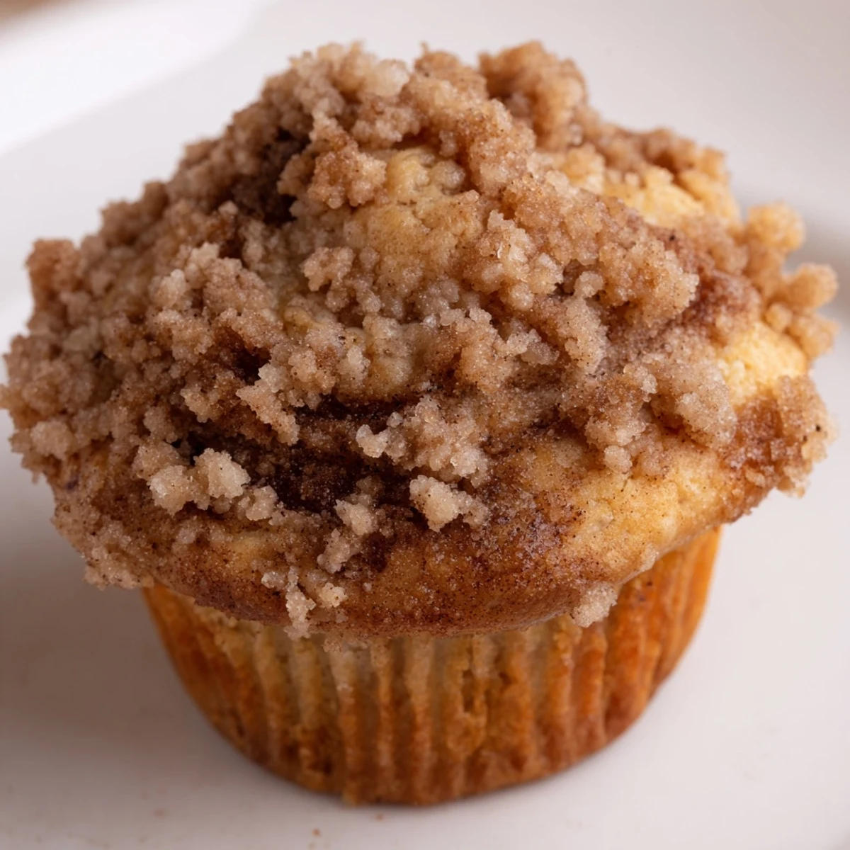 Warm, freshly baked Lightened Christmas Coffee Cake Muffins with a delicate swirl, perfect for a cozy breakfast.