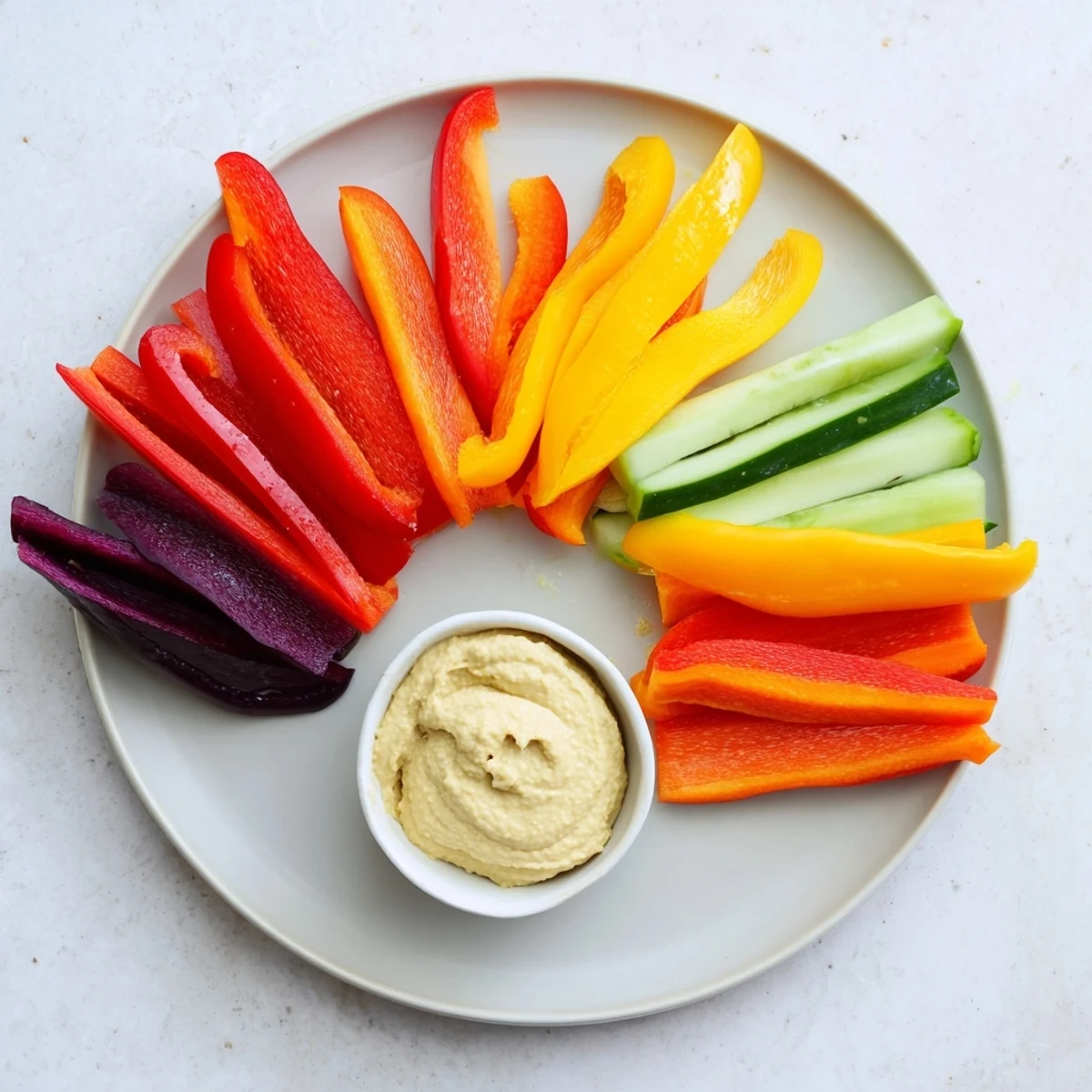 Rainbow Arch Veggie Sticks arranged in a colorful arc with cooling cucumber and sweet pepper slices on display.