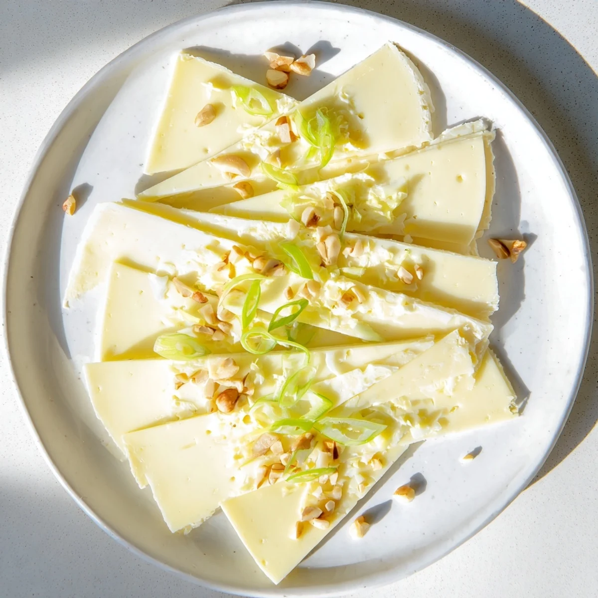 Fresh chives and walnuts top this easy Swiss cheese slices appetizer, ready to enjoy.