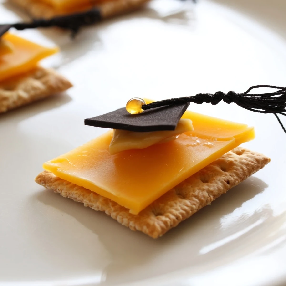 These adorable Graduation Cap Snacks feature vibrant dried fruit tassels, a fun appetizer for celebrations.