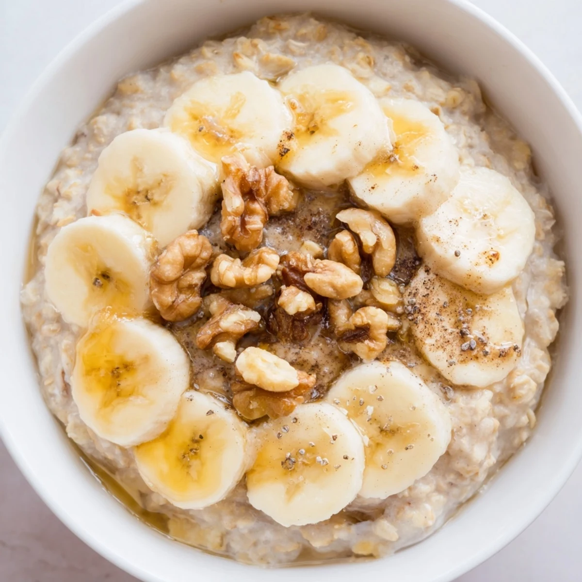 Steaming, creamy Microwave Banana Oats topped with fresh banana slices, ready in minutes for a great breakfast.