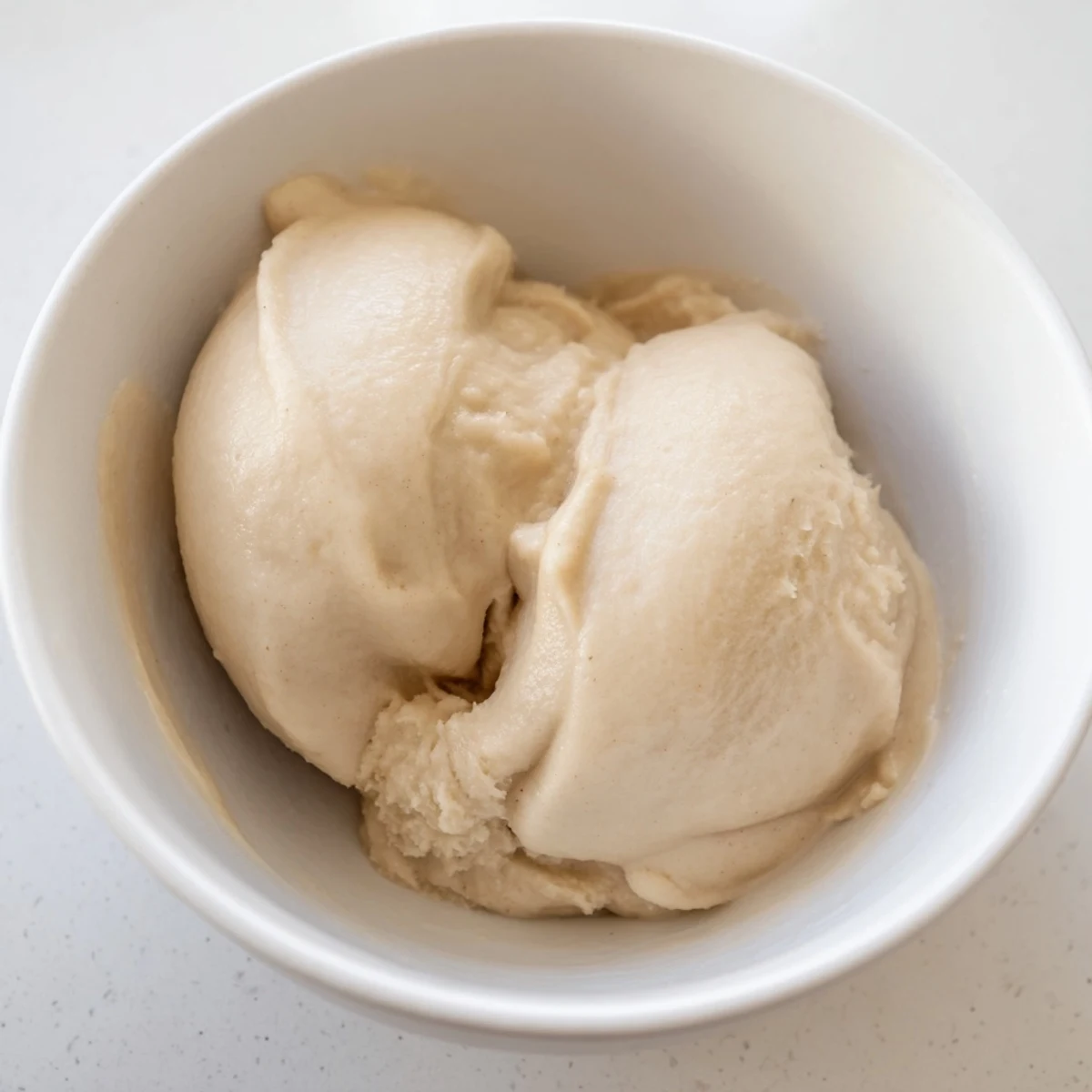 Smooth 2-Ingredient Banana Ice Cream, perfectly frozen and blended until achieving a delightful soft-serve texture.