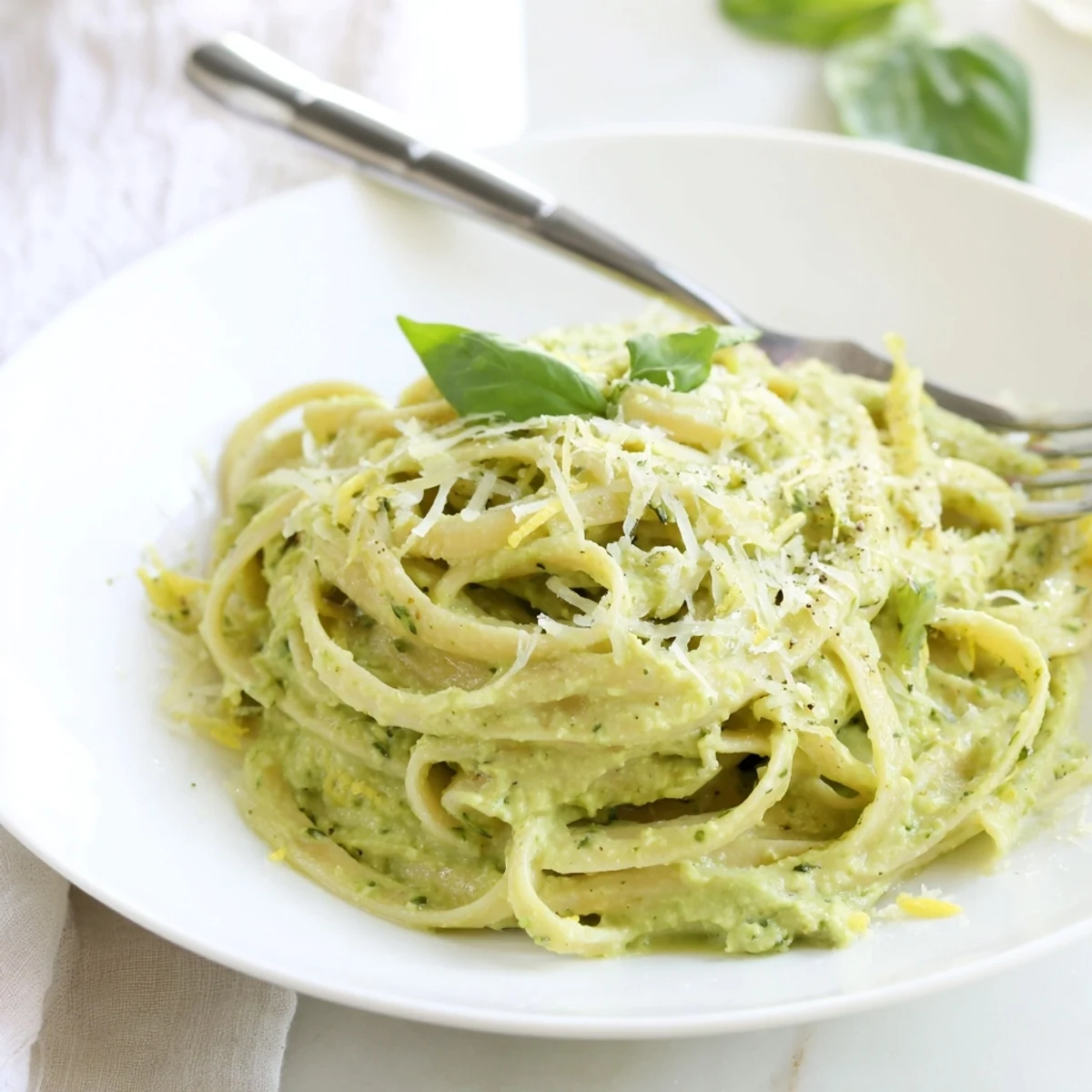 Freshly made Creamy Avocado Pasta with basil and Parmesan, promising a burst of delicious flavors.