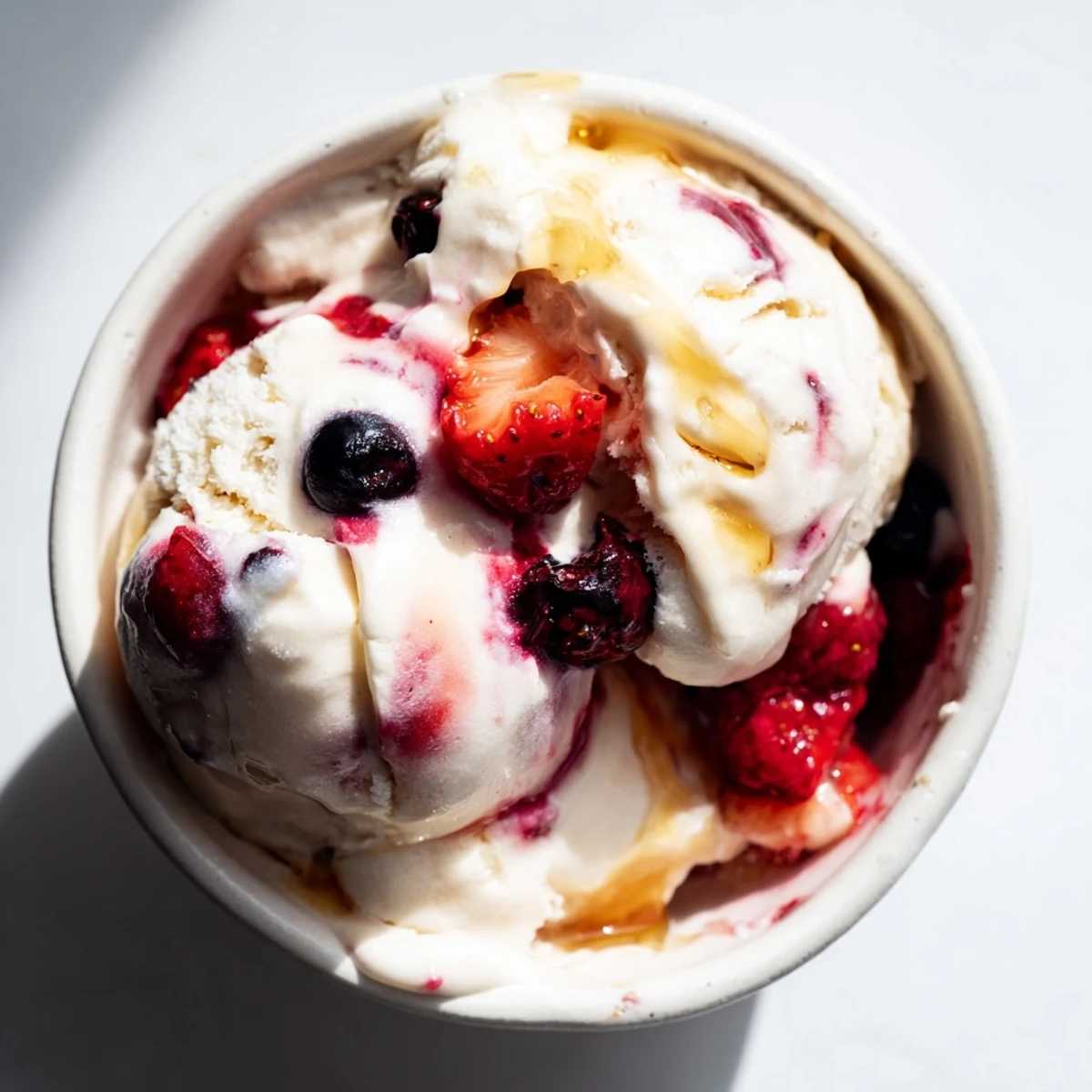 Creamy Cottage Cheese Ice Cream, swirled with purple berries, looks refreshing and ready to scoop.