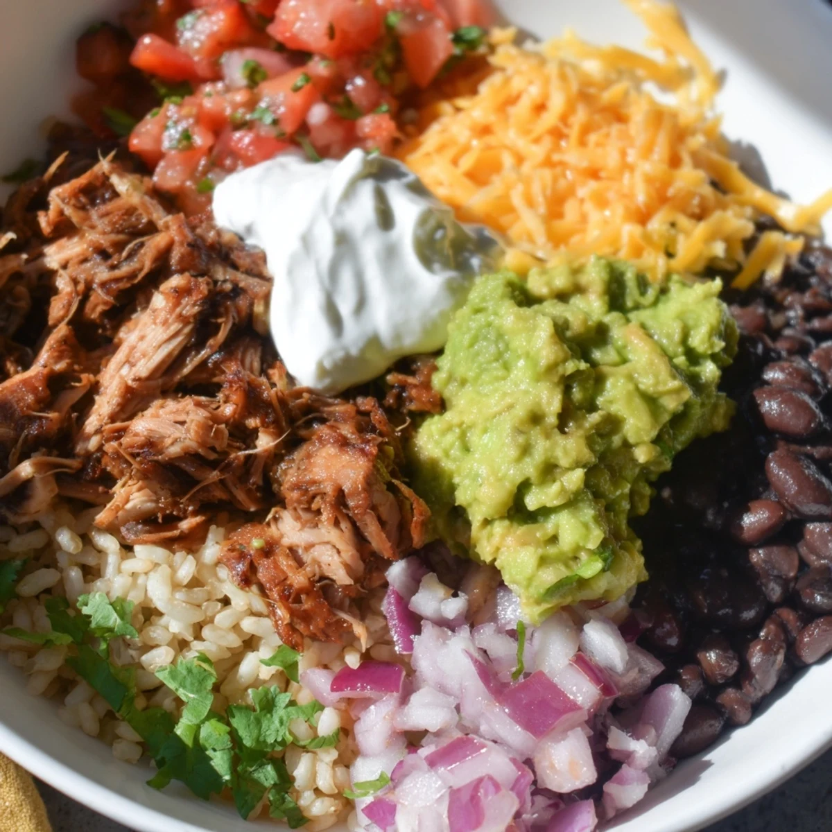 A flavorful Chipotle Burrito Bowl copycat with tender pork carnitas and creamy queso.