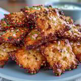 Crispy homemade sourdough crackers topped with everything seasoning and sharp cheddar cheese.