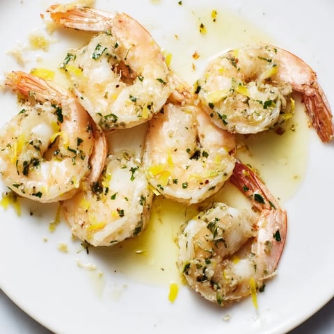 Succulent garlic herb butter shrimp glistening in a rich sauce, ready to serve.