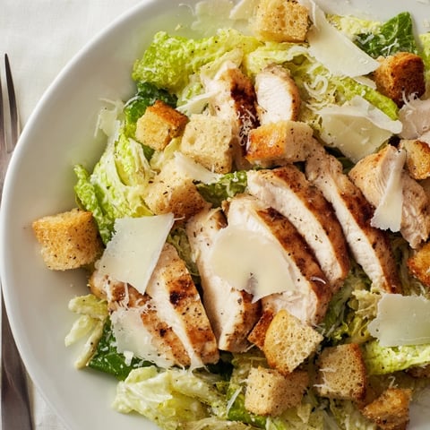 Grilled Chicken Caesar Salad with juicy chicken, crisp lettuce, and creamy dressing.