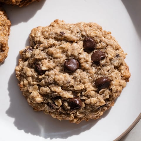 Warm, golden Oat-Banana Chocolate Chip Cookies, perfect with a glass of milk, fresh from the oven.