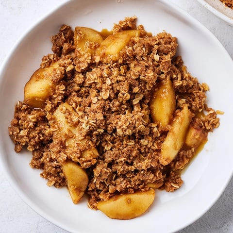 Golden brown Apple Crisp with a bubbly, cinnamon-infused apple filling ready to serve.