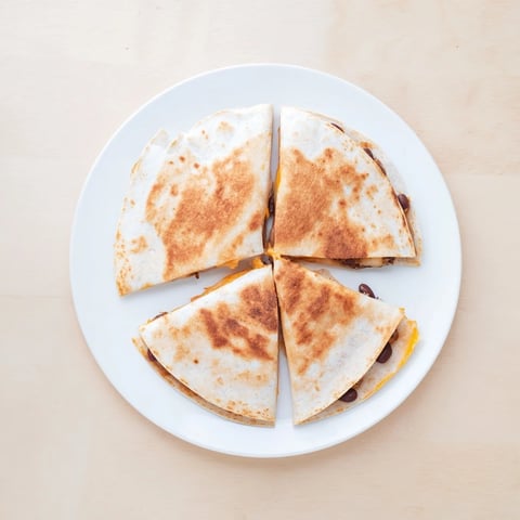 Golden, crispy Bean & Cheese Quesadillas are filled with melted cheese, ready for dipping into salsa.