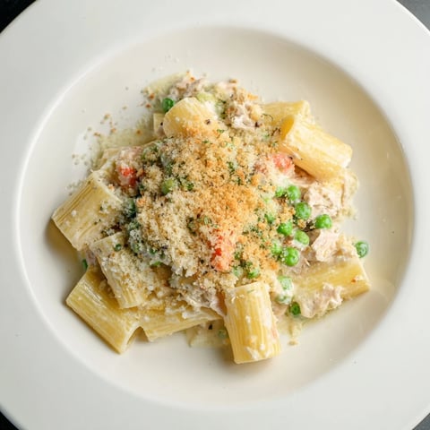 Golden brown tuna pasta bake bubbling in a baking dish, ready for serving.