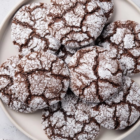 Warm, crackled Chocolate Gingerbread Crinkle Cookies dusted in powdered sugar, ready to savor.