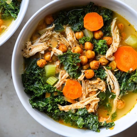 Chicken Kale Soup topped with golden, crunchy chickpeas, a healthy and satisfying bowlful.