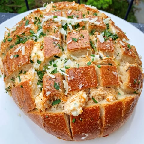 Golden, bubbling Cheesy Leftover Chicken Bake Pull-Apart Bread with perfectly melted cheese and herbs.