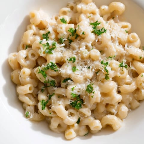Creamy ditalini pasta with garlic, topped with fresh parsley, ready to serve and enjoy.