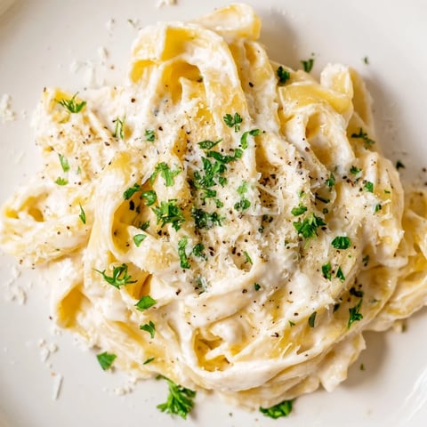Creamy Cottage Cheese Alfredo Sauce, ready to pour over pasta, showcases a light and delicious texture.
