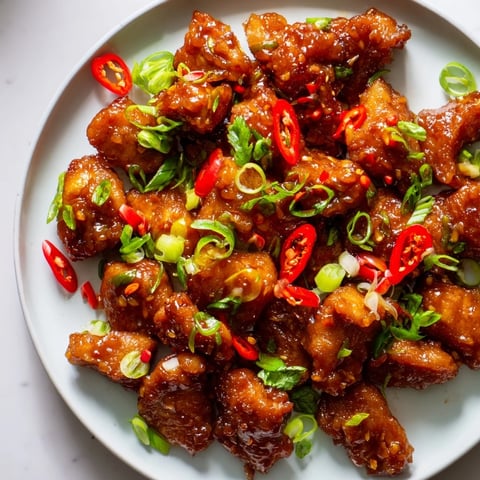 Golden, glazed Vietnamese Caramel Chicken, beautifully garnished, ready to serve with fragrant jasmine rice.