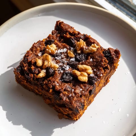 Warm sweet potato brownies, featuring a crackly top and moist interior, perfect for dessert.