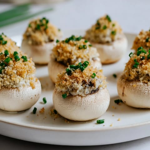 Appetizing close-up of herb-filled Stuffed Mushroom Caps, ready to serve as a tasty appetizer.
