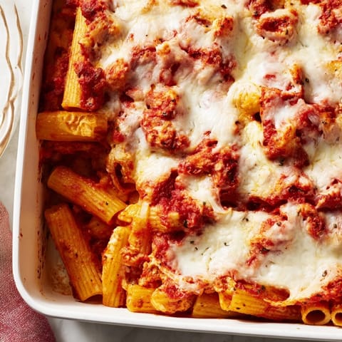 A steaming slice of Freezer Make-Ahead Baked Ziti reveals creamy ricotta layers and perfectly cooked ziti pasta.  