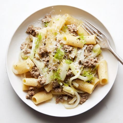 Warm Winter Pasta with Sausage and Fennel served in a bowl, showcasing golden pasta, tender fennel slices, and savory crumbles of Italian sausage.
