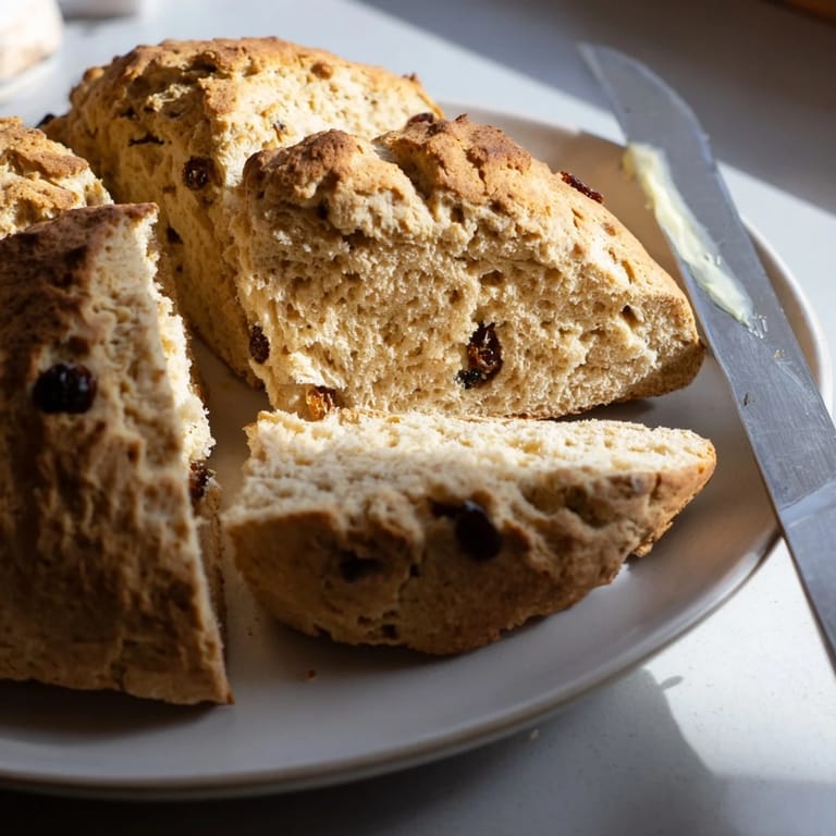 Warm slices of Classic Irish Soda Bread served with creamy butter and homemade jam.  