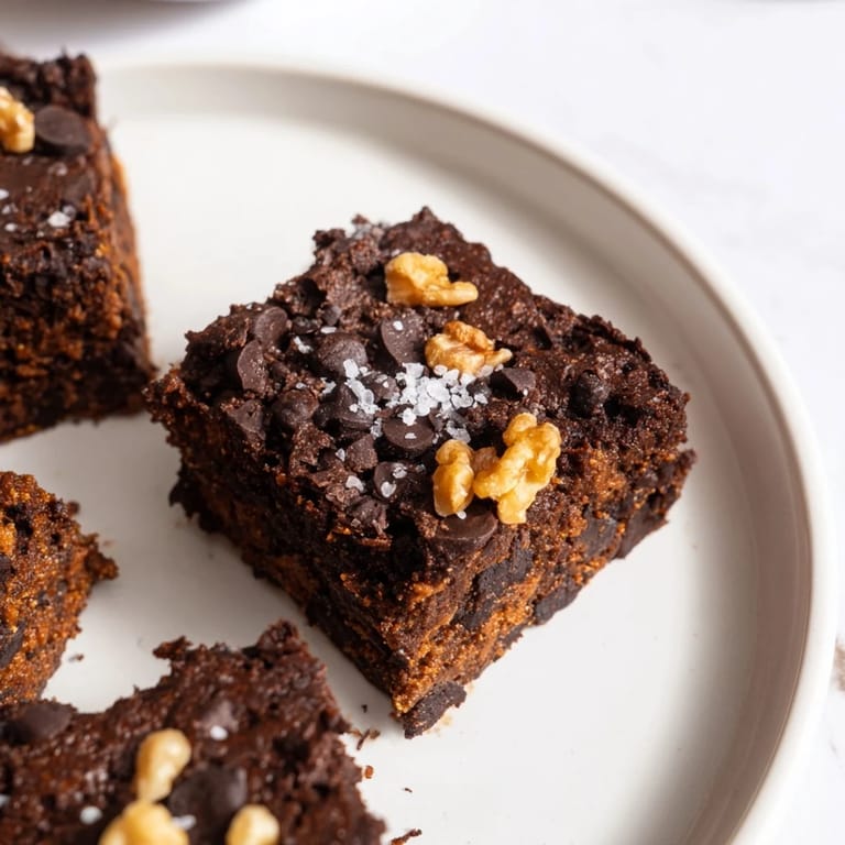 A plate of delicious sweet potato brownies, a gluten-free dessert packed with chocolatey goodness.