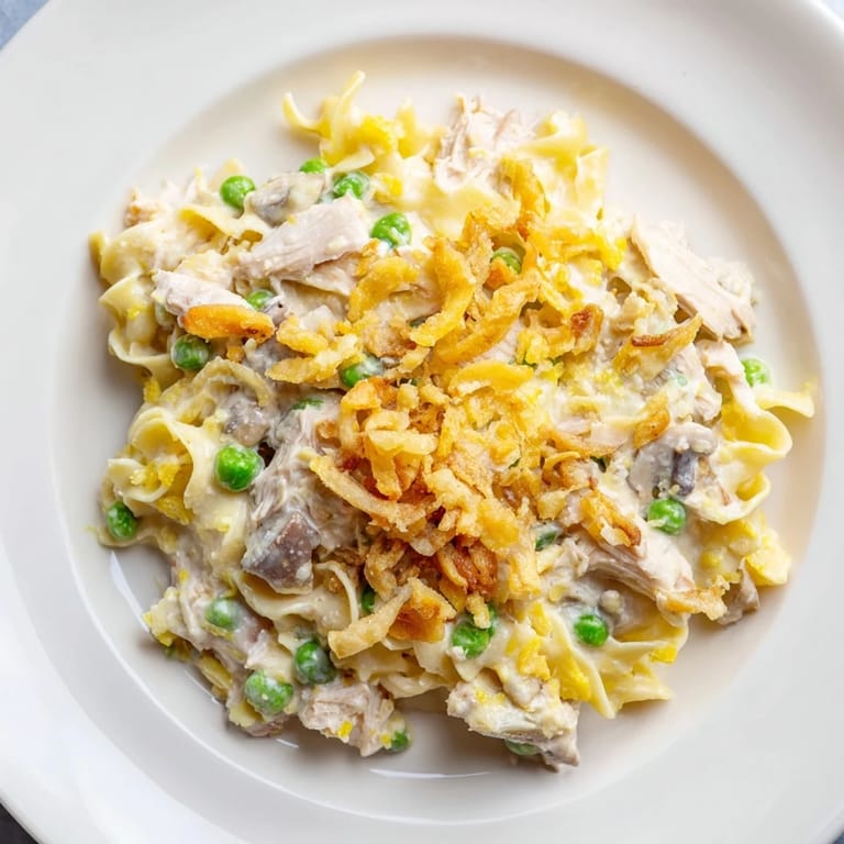 Warm and comforting creamy tuna noodle casserole, a classic American dish with fresh toppings.