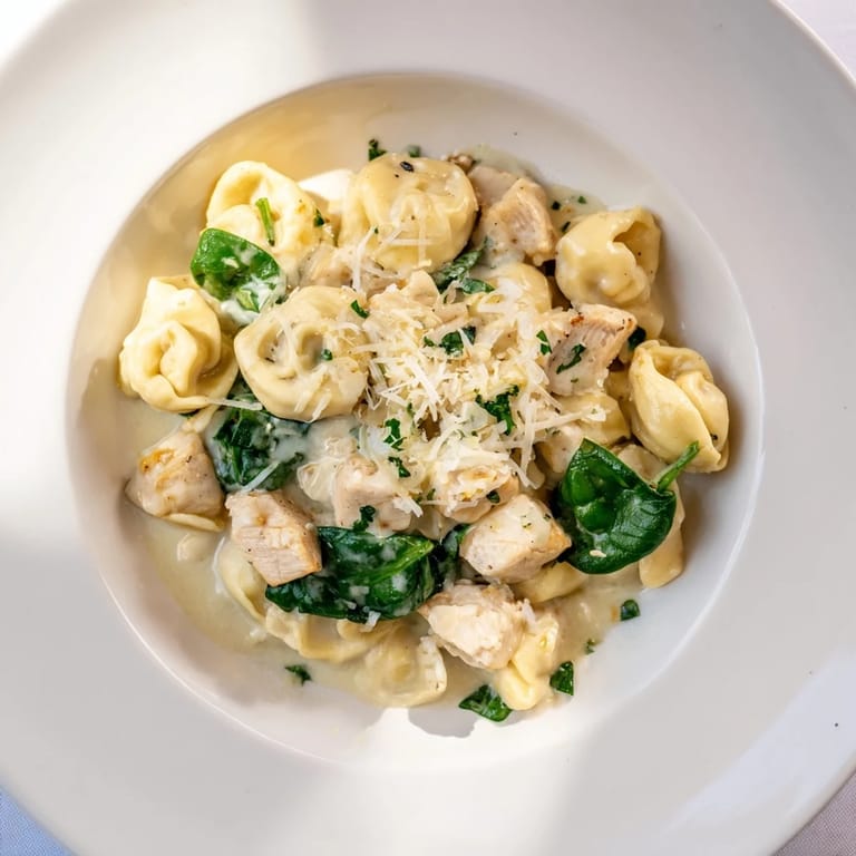 Tender chicken pieces mingle with spinach and tortellini in this delicious creamy Chicken and Spinach Tortellini.