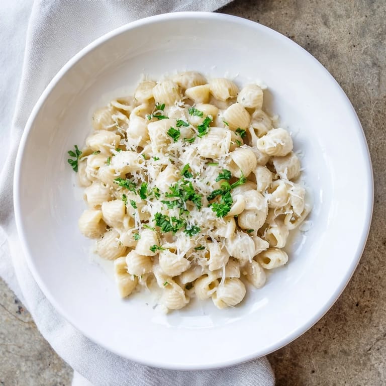 Golden, savory ditalini pasta coated in garlic cream, a tasty Italian-American delight.
