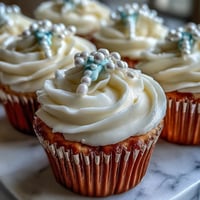 Mini First Communion Cupcakes with Rosary Fondant Toppers: Elegant vanilla mini cupcakes topped with creamy buttercream and delicate fondant rosary toppers for a sacred celebration.